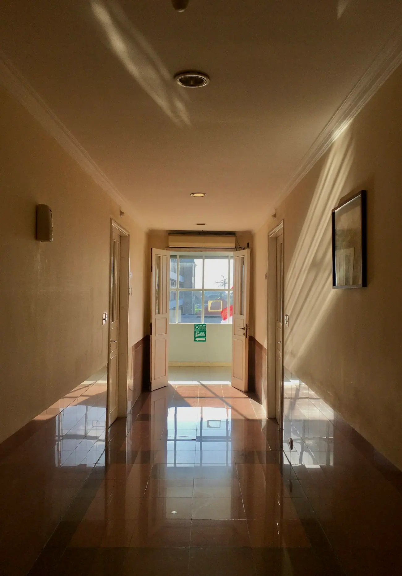 A large interior floor being restored to a high-gloss finish.